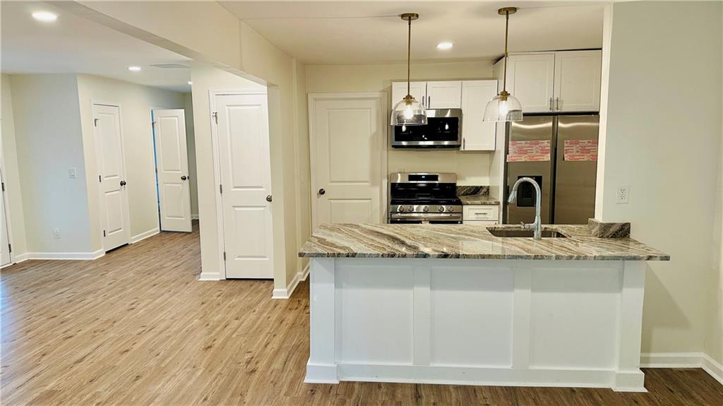 3428 Chapel Park Drive Decatur, GA 30034 - Photo 4 of 35 a kitchen with stainless steel appliances granite countertop a sink a stove and a refrigerator