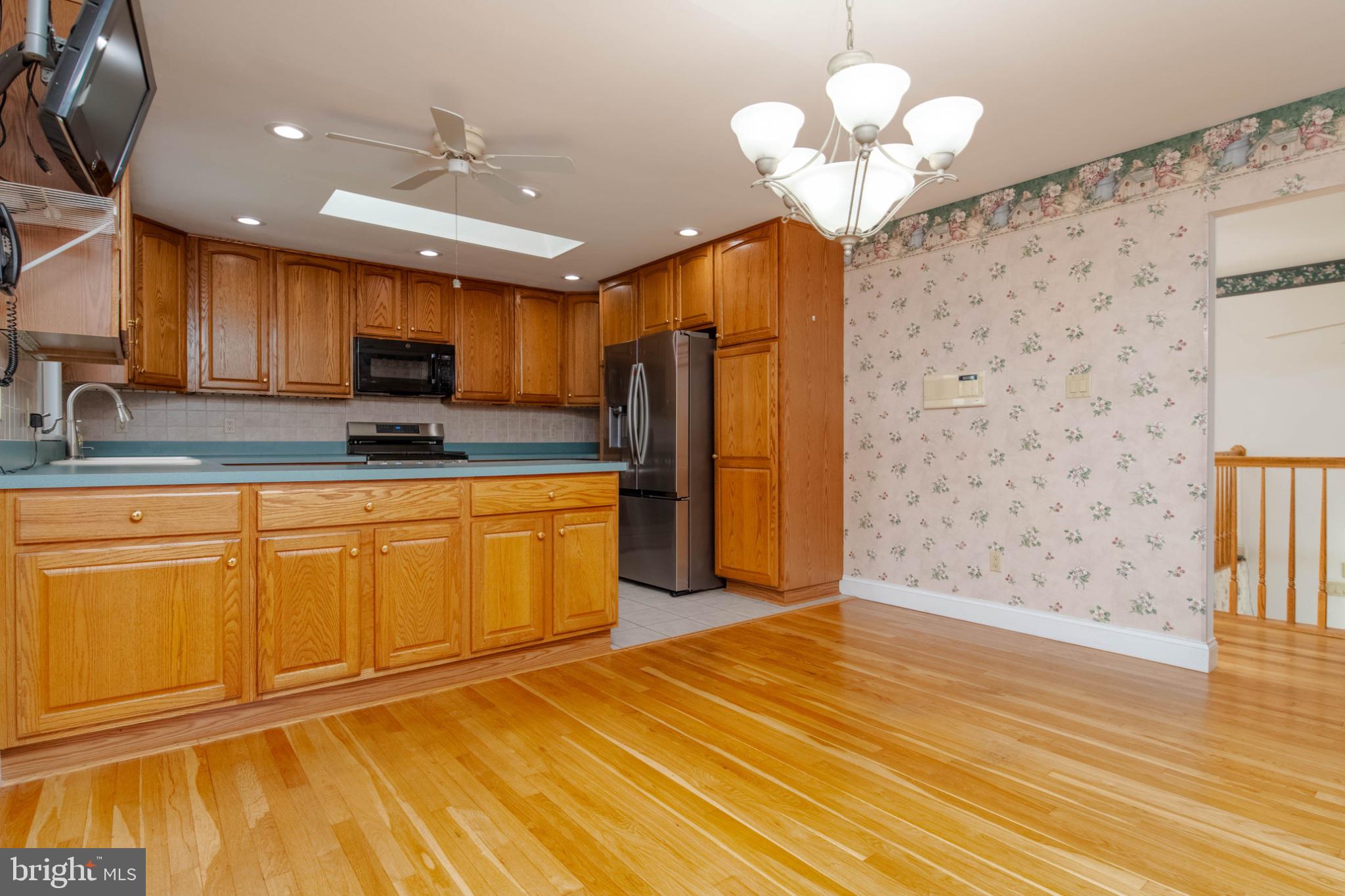 1909 Nelson Mill Road Jarrettsville, MD 21084 - Photo 23 of 65 a kitchen with stainless steel appliances granite countertop a stove a sink dishwasher and a refrigerator with wooden floor