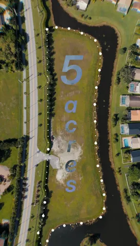 an aerial view of a residential houses with outdoor space