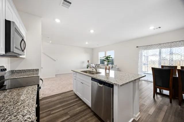 a view of a dining room with furniture and wooden floor