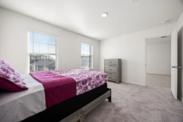 a bedroom with a bed and window