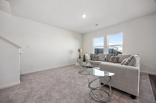 a living room with furniture and a table