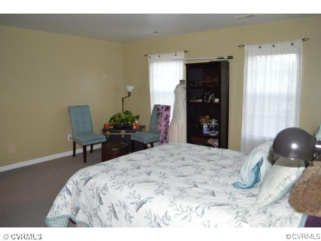 3233 Ransom Hills Road Richmond, VA 23237 - Photo 8 of 15 a bedroom with a bed and a chair