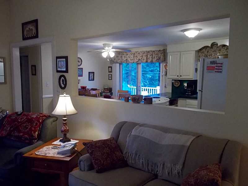 Living Room. Air conditioning is important, but there is a great cross breeze from font door  to the kitchen