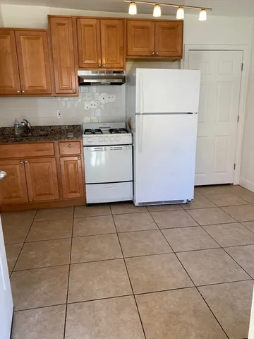 a white refrigerator freezer sitting in a kitchen
