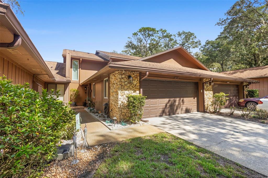 920 Shady Branch Trail DeLand, FL 32724 - Photo 13 of 46 a front view of a house with a yard outdoor seating and garage