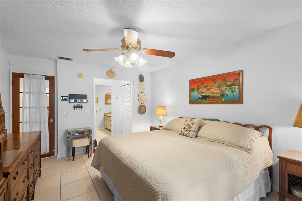 920 Shady Branch Trail DeLand, FL 32724 - Photo 32 of 46 a bedroom with a large bed and a chandelier