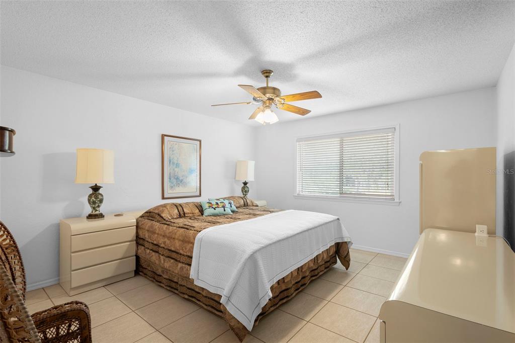 920 Shady Branch Trail DeLand, FL 32724 - Photo 35 of 46 a bedroom with a bed and a chandelier