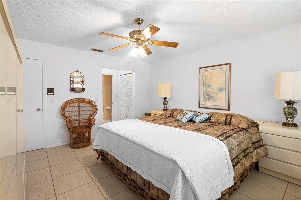 920 Shady Branch Trail DeLand, FL 32724 - Photo 36 of 46 a bedroom with a bed and a chandelier