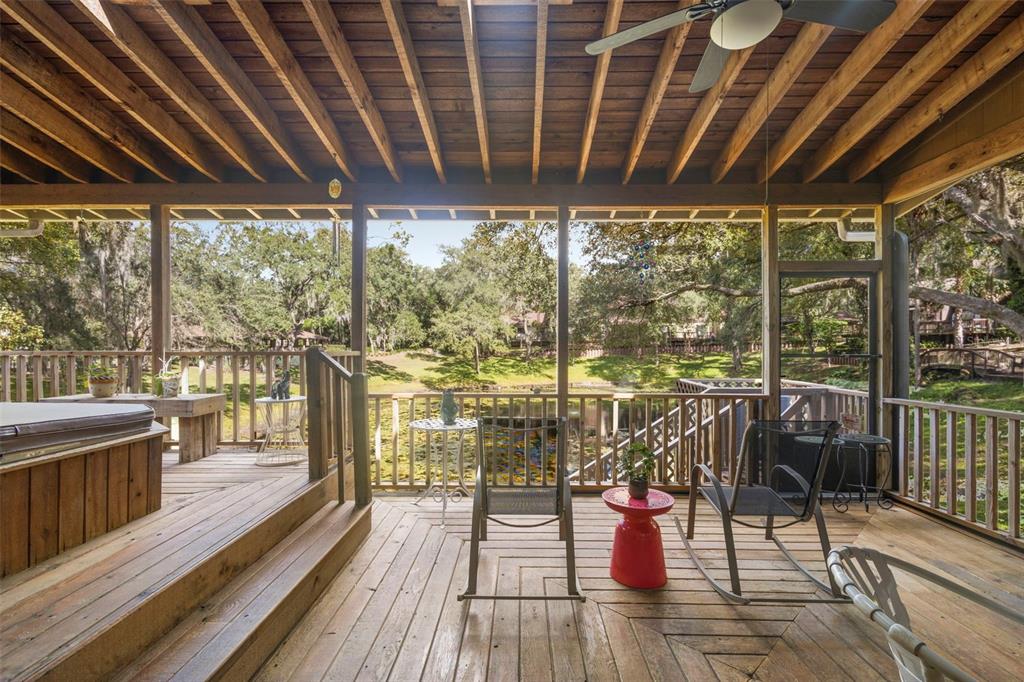 920 Shady Branch Trail DeLand, FL 32724 - Photo 42 of 46 a view of a chairs and table on the wooden deck