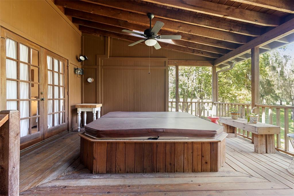 920 Shady Branch Trail DeLand, FL 32724 - Photo 43 of 46 a room with wooden floors and large windows