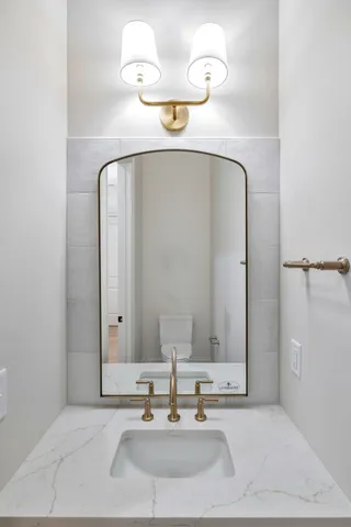 a kitchen with kitchen island a sink and a stove