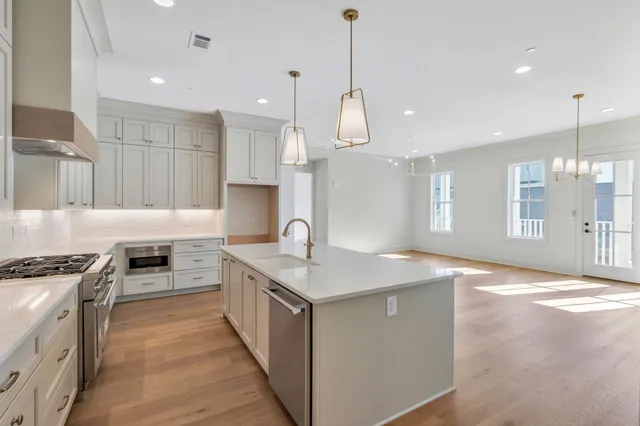 a stove top oven sitting inside of a kitchen