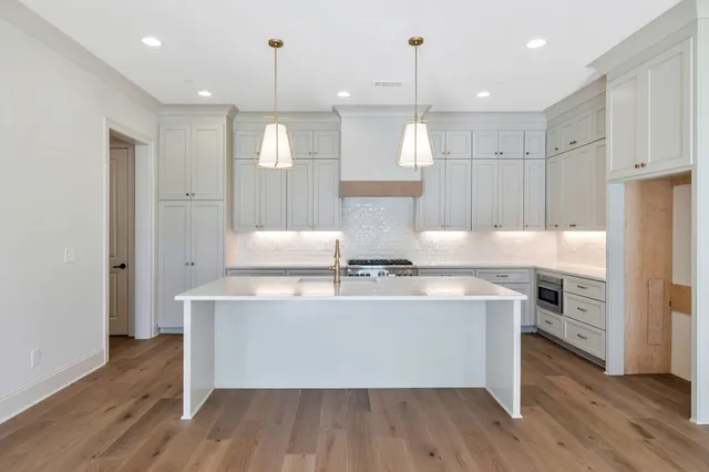 a kitchen with granite countertop a sink and a stove
