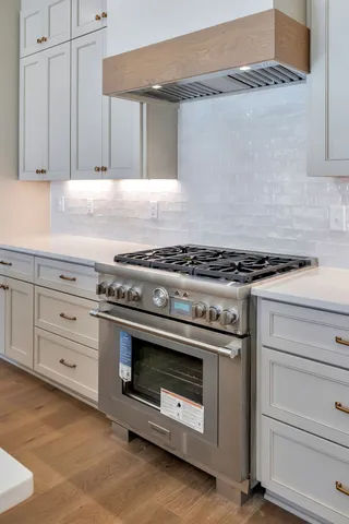 a kitchen with granite countertop a stove and a sink