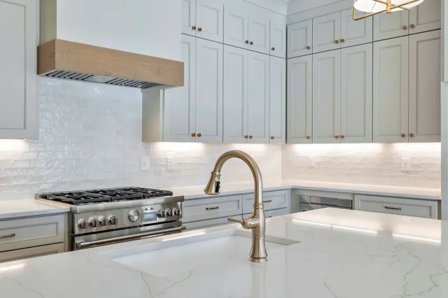 a kitchen with granite countertop white cabinets and white appliances