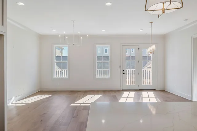 a view of a room with wooden floor and windows