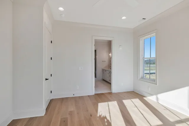 a bathroom with a granite countertop double vanity sink and a mirror