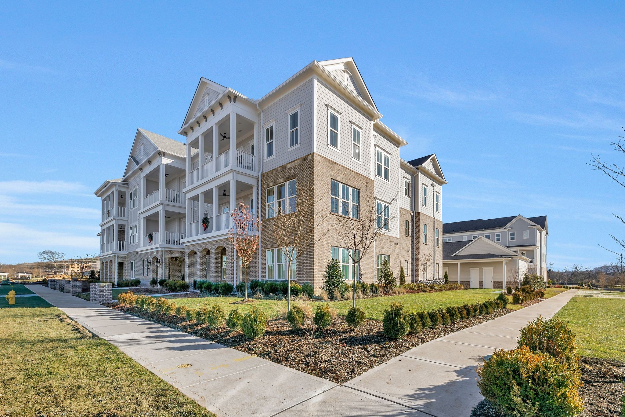 6037 Whitman Road, Unit 202 Franklin, TN 37064 - Photo 3 of 51 a front view of a multi story residential apartment building with a yard