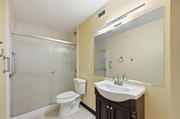 a bathroom with a sink toilet and a mirror