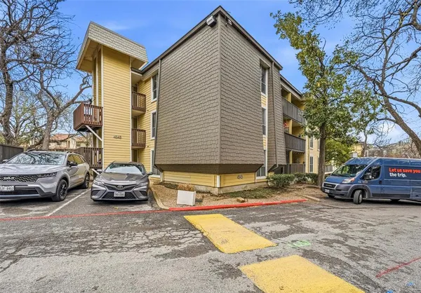 a view of a car parked in front of a house