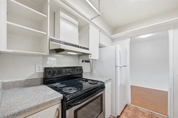 a kitchen with a stove and a refrigerator