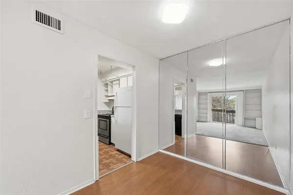 a view of a kitchen with a sink and refrigerator