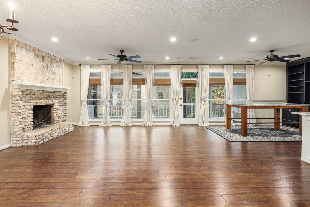 717 Double Churches Road Columbus, GA 31904 - Photo 26 of 54 an empty room with wooden floor and fireplace