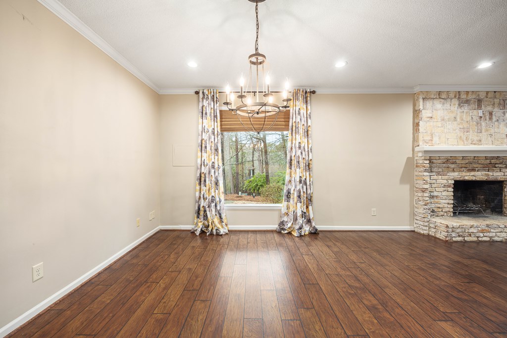 717 Double Churches Road Columbus, GA 31904 - Photo 28 of 54 a view of a room with wooden floor a fireplace and windows