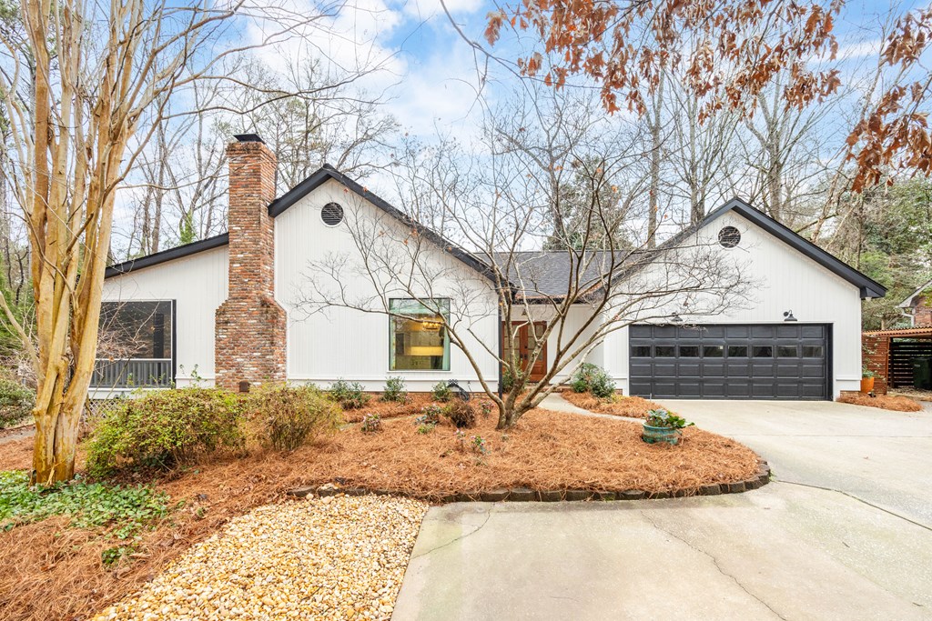 717 Double Churches Road Columbus, GA 31904 - Photo 4 of 54 a front view of a house with a yard covered with snow in front of house