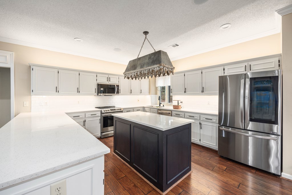 717 Double Churches Road Columbus, GA 31904 - Photo 41 of 54 a kitchen with a sink stainless steel appliances and white cabinets