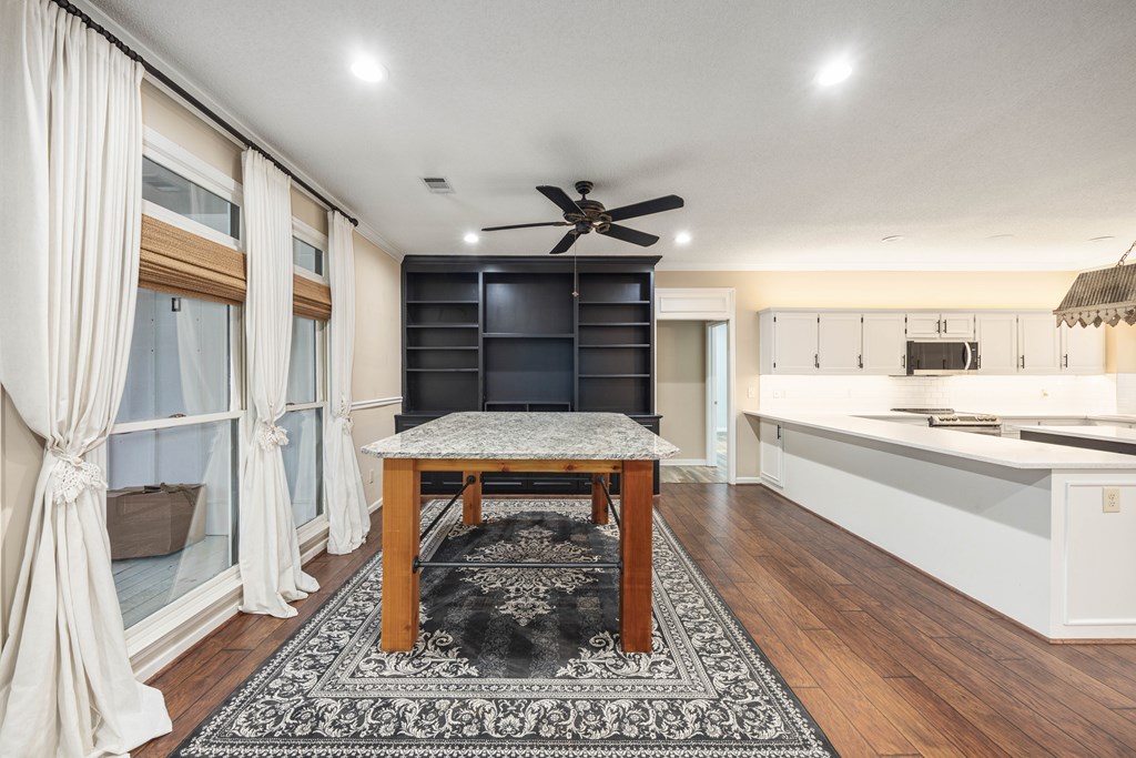 717 Double Churches Road Columbus, GA 31904 - Photo 42 of 54 a living room with stainless steel appliances furniture a rug and a fireplace