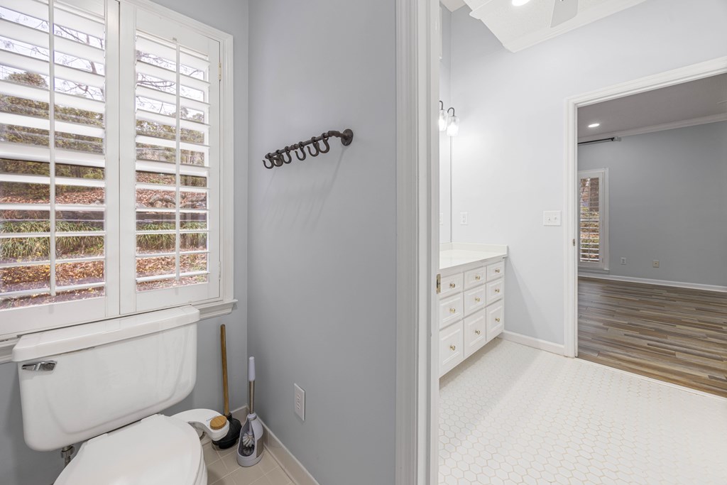 717 Double Churches Road Columbus, GA 31904 - Photo 44 of 54 a bathroom with a toilet a sink and a window
