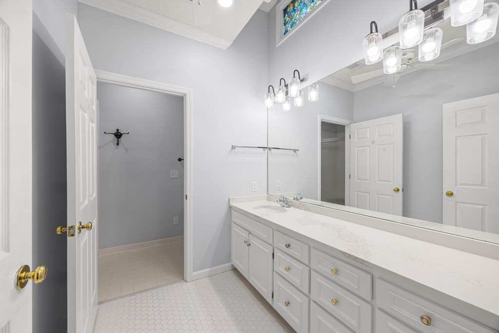 717 Double Churches Road Columbus, GA 31904 - Photo 46 of 54 a spacious bathroom with a granite countertop sink a mirror and a shower
