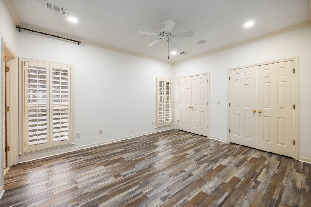 717 Double Churches Road Columbus, GA 31904 - Photo 49 of 54 an empty room with wooden floor and windows