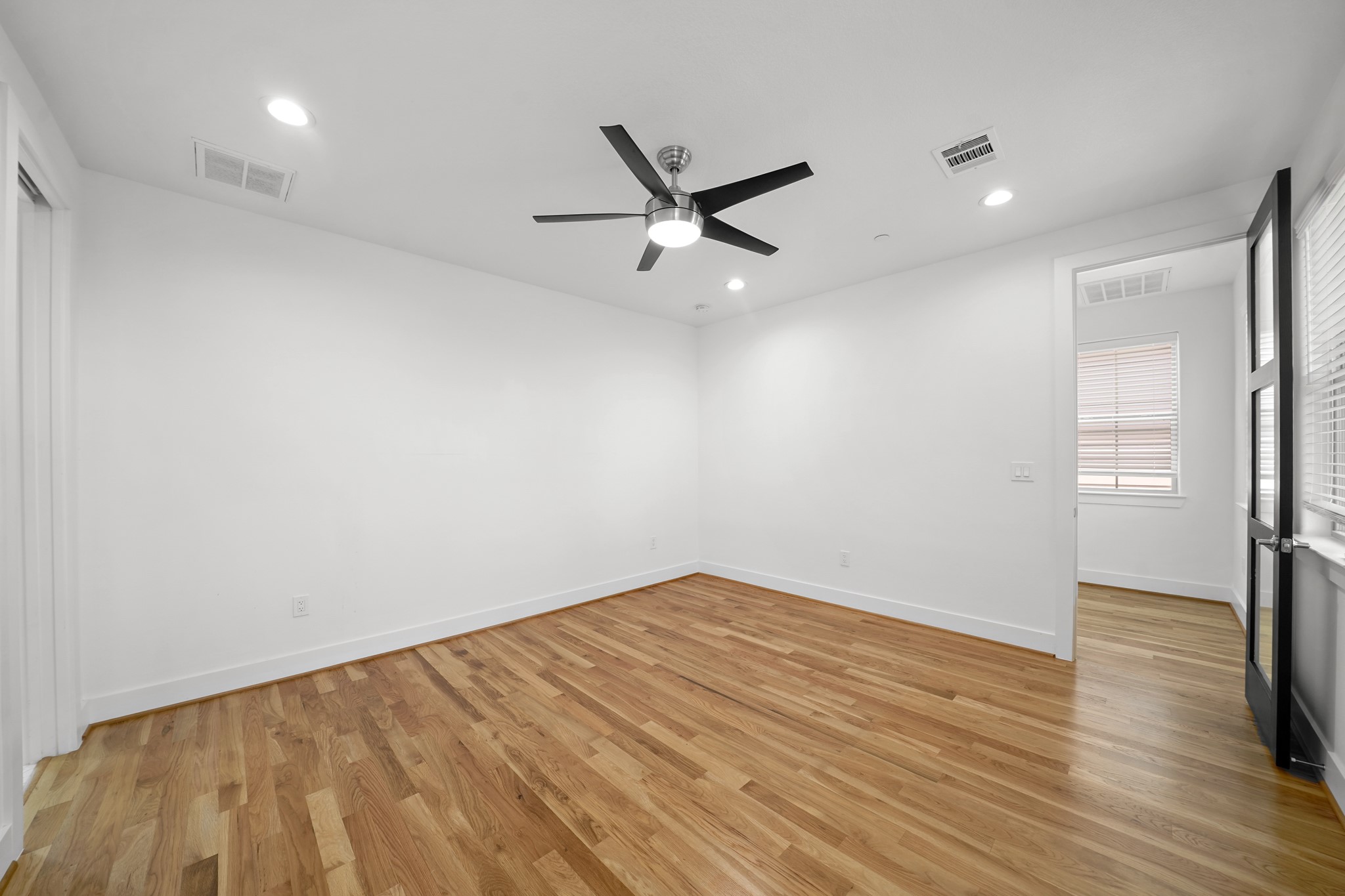 5343 Larkin Street Houston, TX 77007 - Photo 7 of 21 wooden floor in an empty room with a window