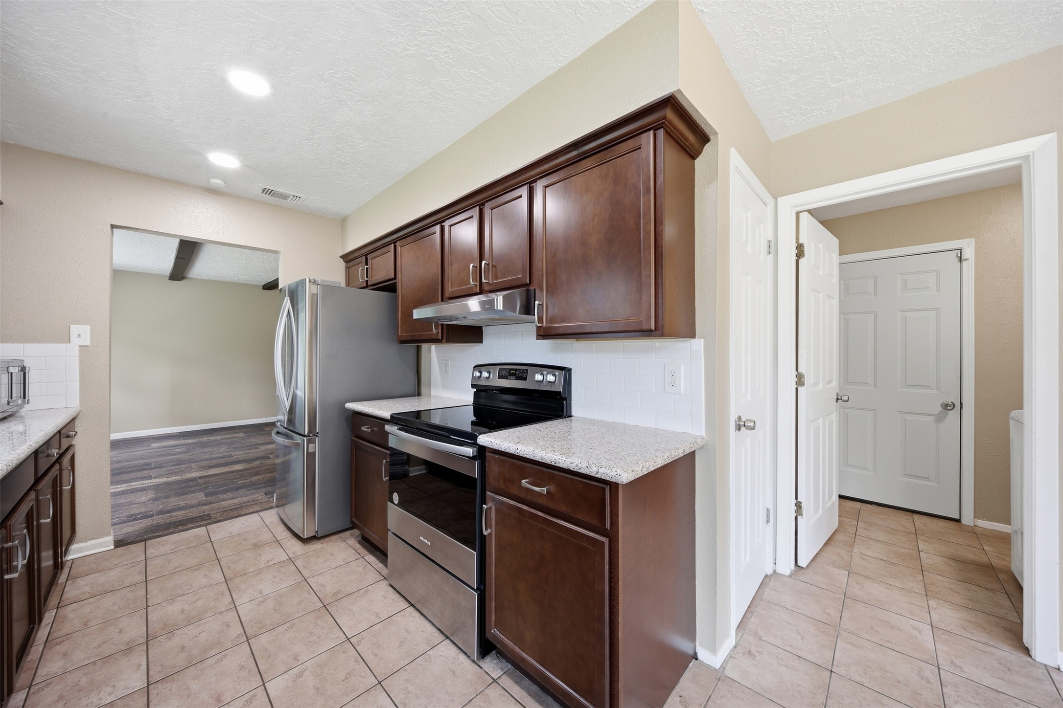 9418 Kilrenny Drive Spring, TX 77379 - Photo 26 of 47 a kitchen with stainless steel appliances granite countertop a refrigerator and a stove