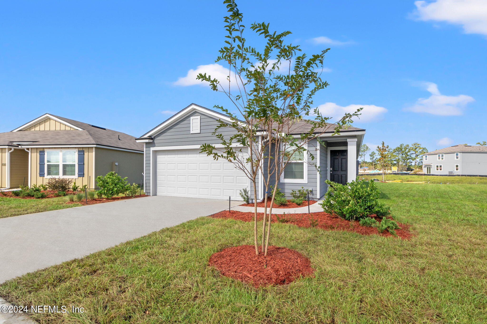 12567 Rubber Fig Terrace Jacksonville, FL 32218 - Photo 3 of 21 a front view of a house with a yard