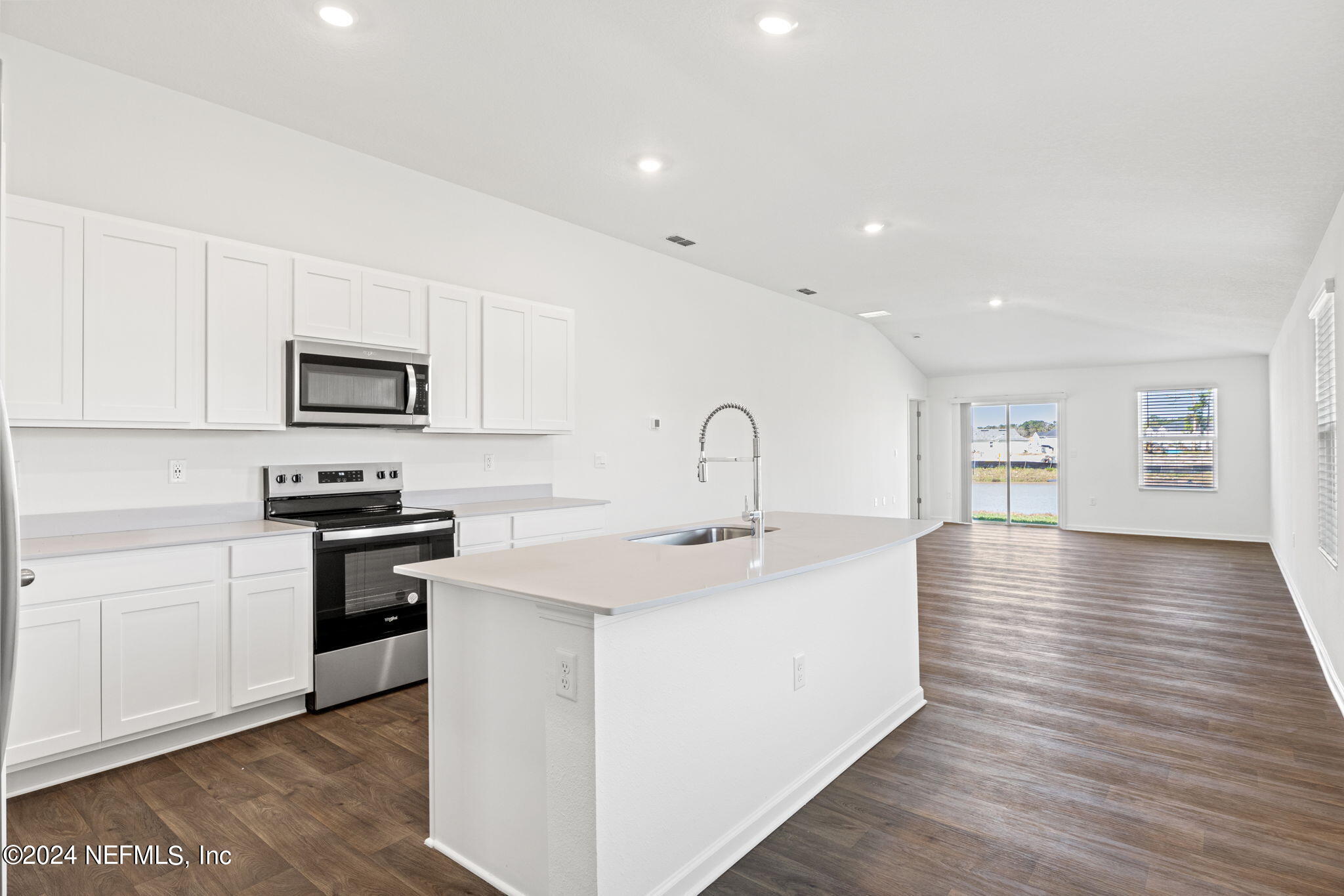 12567 Rubber Fig Terrace Jacksonville, FL 32218 - Photo 4 of 21 a kitchen with stainless steel appliances granite countertop a sink and stove top oven