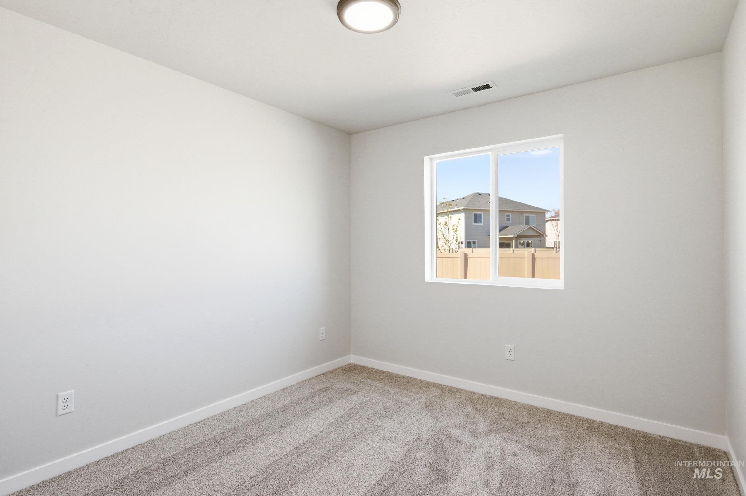 12877 Decatur Street Nampa, ID 83651 - Photo 15 of 22 Room featuring light gray walls, gray patterned carpet flooring, and white baseboards