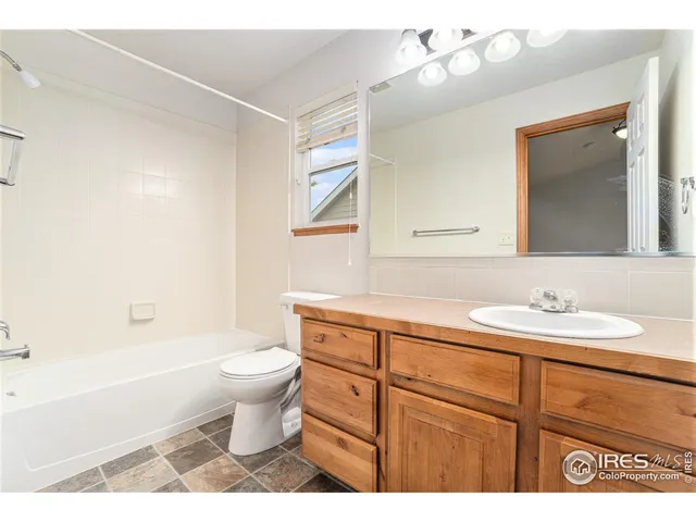 a bathroom with a sink a toilet a mirror and vanity
