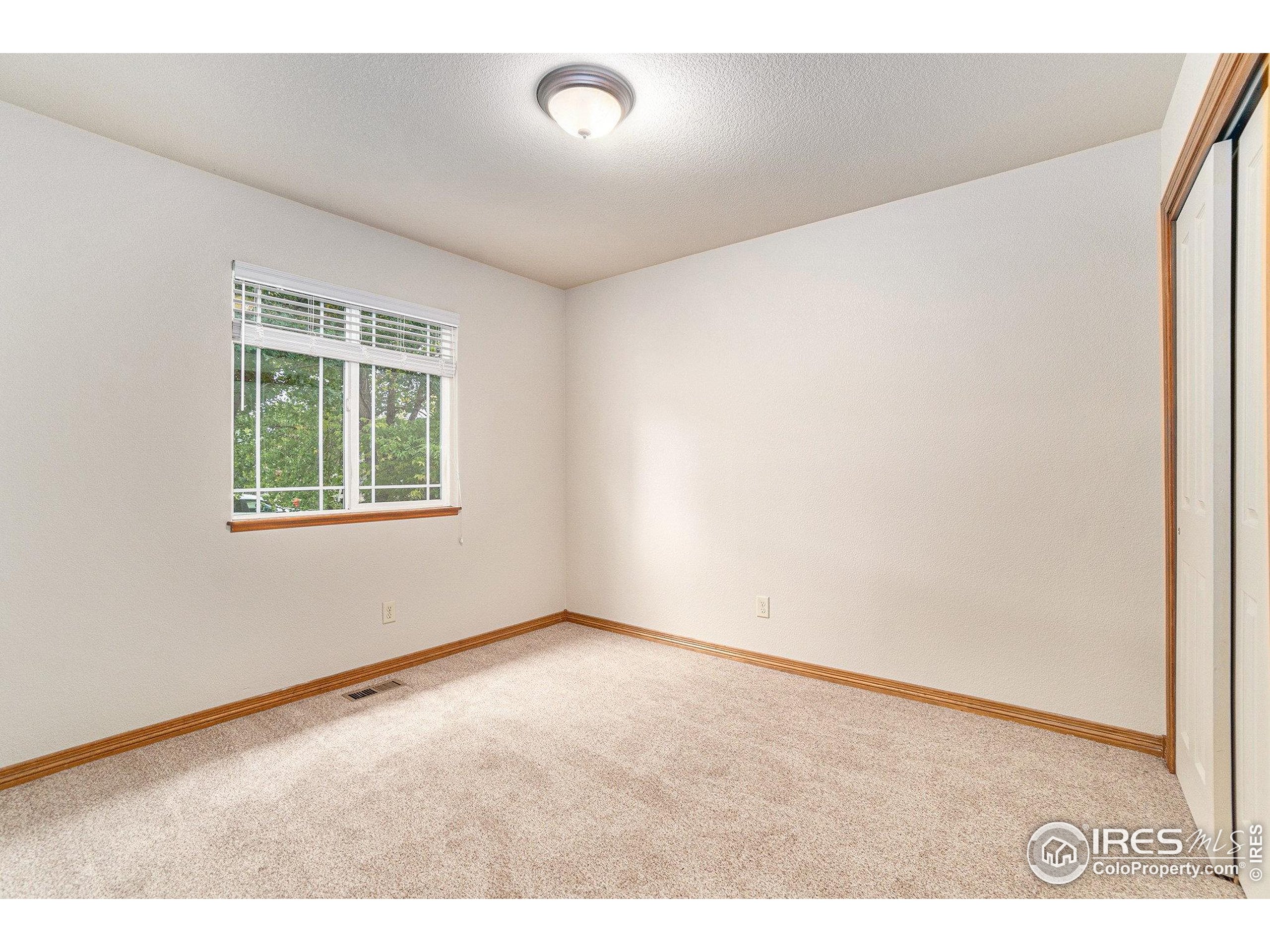 3474 Iron Horse Way Wellington, CO 80549 - Photo 15 of 20 an empty room with windows
