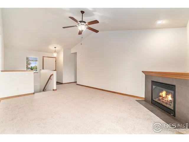 a view of an empty room with a fireplace
