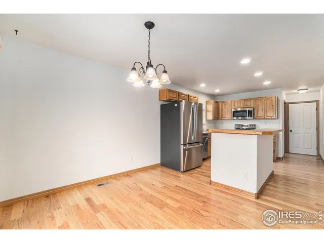 a view of kitchen with refrigerator microwave and stove