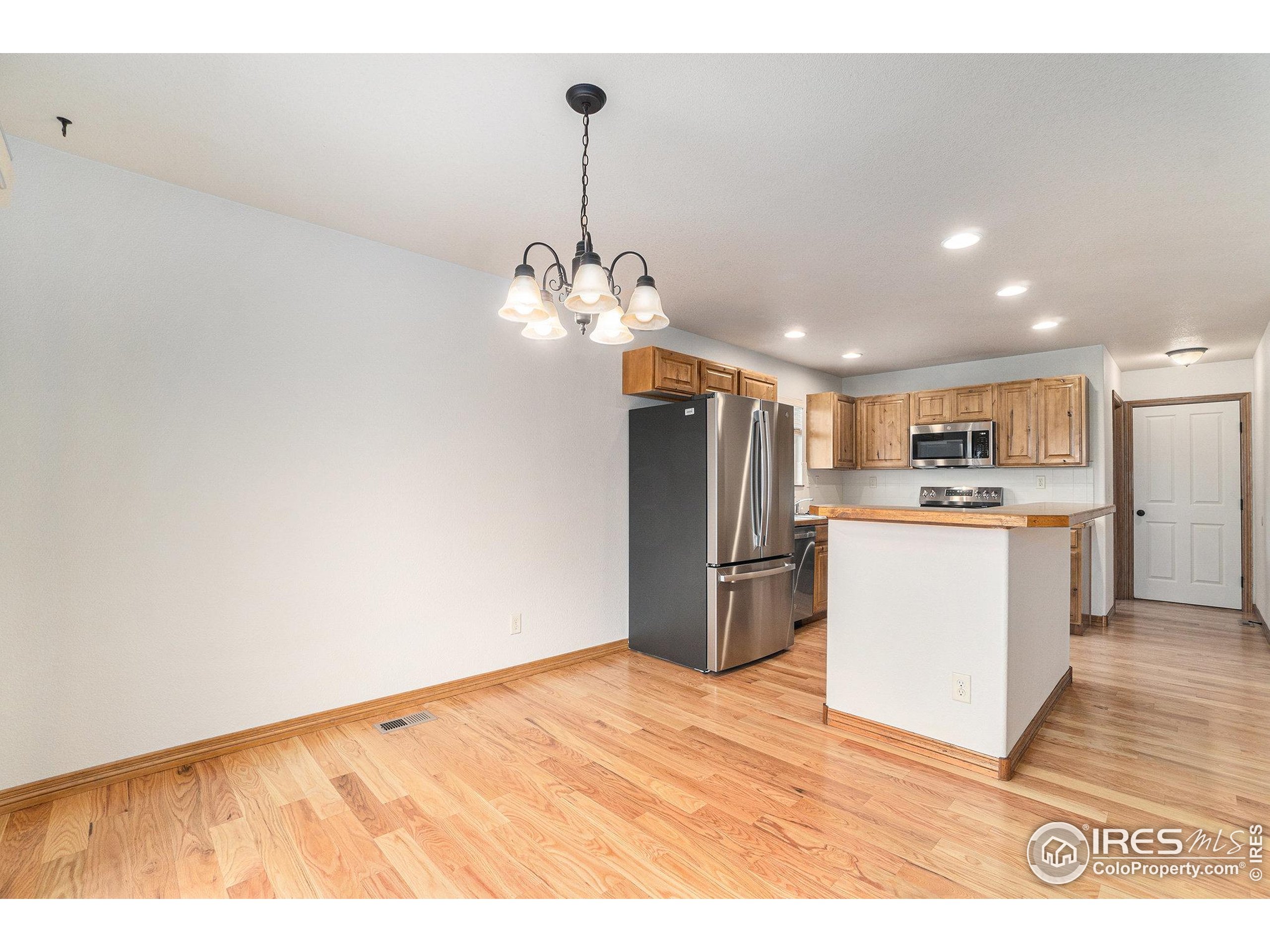 3474 Iron Horse Way Wellington, CO 80549 - Photo 5 of 20 a view of kitchen with refrigerator microwave and stove