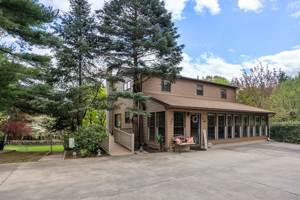 575 Piper Road West Springfield, MA 01089 - Photo 2 of 40 a view of a white house with large windows and a large tree
