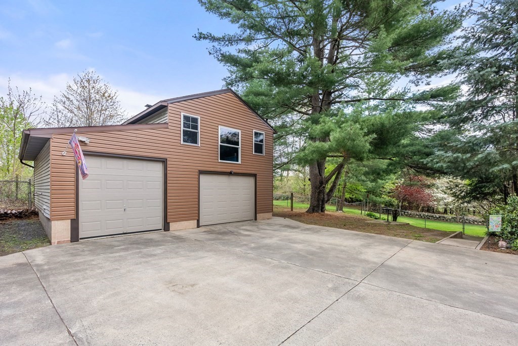 575 Piper Road West Springfield, MA 01089 - Photo 39 of 40 a view of a house with a yard and garage