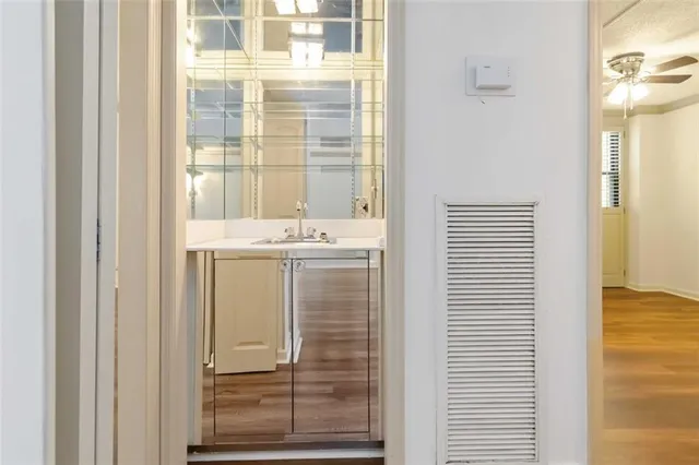 a utility room with washing machine and cabinets