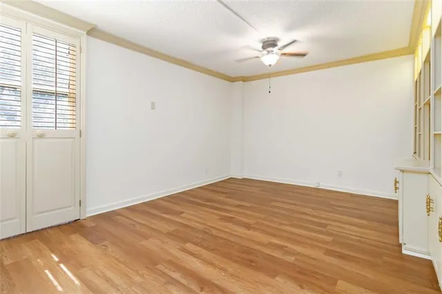 a view of a room with a ceiling fan and a window