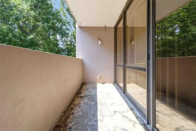 a balcony with view of outdoor space